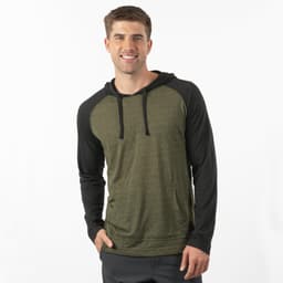 A yarn-dyed long sleeve knit hoodie in green with black sleeves. The model is smiling and wearing the hoodie.