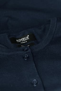 A dark navy cardigan with button closures and a brand label visible.