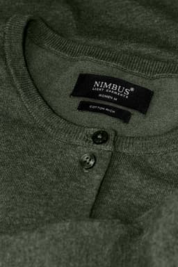 A green cardigan with a buttoned neckline and a stitched label featuring a logo.