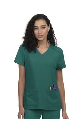 A scrub top in teal green featuring two front pockets and a V-neck design. The model has curly hair and wears it confidently.
