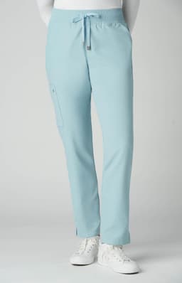 Atria Pant in light blue, featuring a drawstring waist and a side pocket. The model is wearing white shoes.