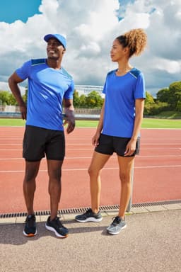 A men's running T-shirt in blue, displayed with matching black shorts, alongside a female model in similar attire.