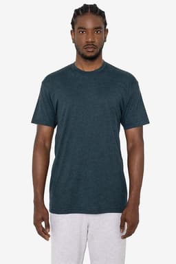 A short sleeve crew tee in a dark teal colour, featuring a subtle logo, displayed on a model.