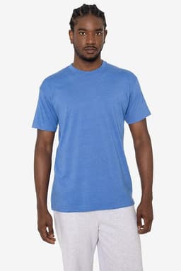 A man wearing a blue short sleeve cotton poly crew tee, standing against a plain background. The shirt has a logo.