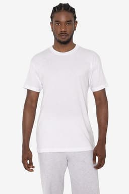 A white short sleeve cotton-poly crew tee on a model, paired with grey sweatpants. The tee features a logo.