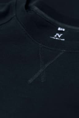 A black sweatshirt with a round neckline and subtle stitching details, featuring a brand logo.