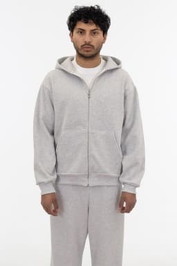 A grey heavy fleece zip-up hoodie with a front zipper and hood, modelled by a person.