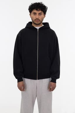 A black heavy fleece zip-up hoodie with a hood, worn by a person standing against a neutral background.