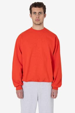 A heavy fleece pullover in vibrant red, featuring long sleeves and a relaxed fit, paired with grey pants.