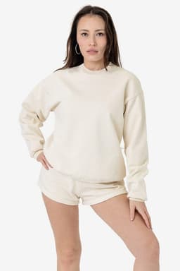 A cream-coloured heavy fleece pullover worn by a model, featuring a relaxed fit and long sleeves.