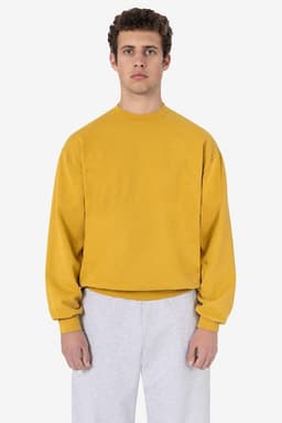 A mustard yellow garment dye heavy fleece pullover, featuring long sleeves and a round neckline.
