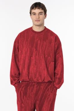 A red heavy fleece pullover with a textured pattern, featuring long sleeves and a relaxed fit.