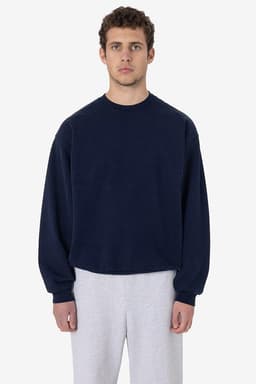 A heavy fleece pullover in navy blue, featuring a crew neck and long sleeves, paired with light grey pants.