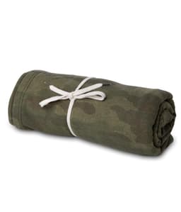 A rolled-up camouflage blanket tied with a white ribbon, featuring shades of green and brown.