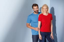 A blue unisex T-shirt worn by a man and a red women's T-shirt worn by a woman, both displayed against a light background.