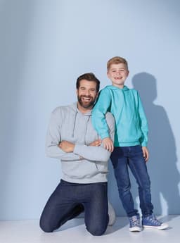 A pair of hooded sweatshirts, one light grey on an adult and one teal on a child, against a light blue background.