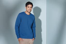 A blue sweatshirt featured on a male model against a light background, with a logo visible on the garment.