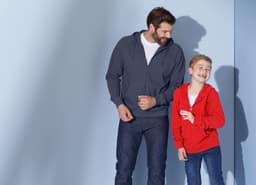 A grey hooded jacket on a man and a red hooded jacket on a boy, both smiling against a light blue background.