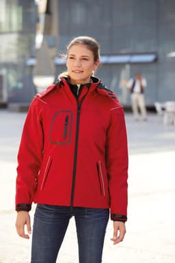 A red ladies winter softshell jacket with a hood, featuring front pockets and a zip closure. The jacket has a branded logo.