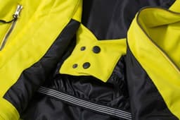 A soft shell jacket in vibrant yellow and black, featuring zippers and snap buttons. It includes a logo.