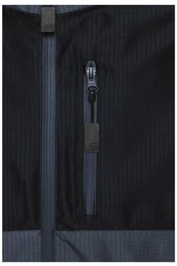 A close-up of a black Hardshell Workwear Jacket featuring multiple zippered pockets and textured fabric.