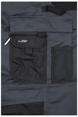 A close-up of dark grey workwear pants featuring a black bib and multiple front pockets, including a logo.