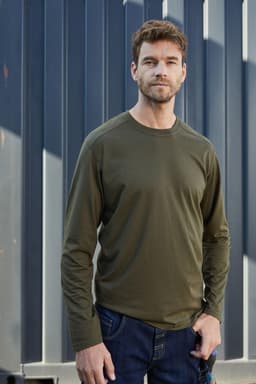 A long-sleeve olive green men's work t-shirt displayed on a model against a textured background.