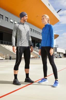 A grey sports jacket and black leggings worn by a man, and a blue sports shirt paired with black leggings worn by a woman.
