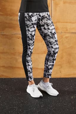 Ladies sports tights in a black and grey abstract print, featuring a fitted design and a logo on the waistband.