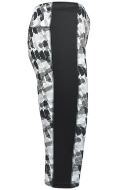 Ladies' 3/4 sports tights featuring a black and grey abstract pattern with a solid black side panel and a logo.
