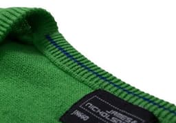 A close-up of a green ladies' V-neck cardigan with blue stitching and a tag featuring a logo.