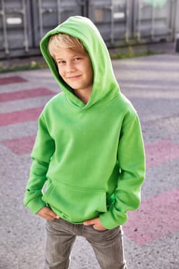 A bright green children's hoodie with a front pocket and a hood, worn by a boy standing outdoors.