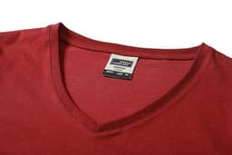 A red ladies' workwear T-shirt featuring a V-neck design and a label inside the neckline.