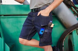 Workwear Stretch Bermuda Jeans in dark blue denim with pockets for tools and sunglasses. Features a belt and relaxed fit.