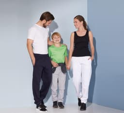 Men's jogging pants in navy, paired with a boy in grey bottoms and a girl in white pants, with a black and green top.