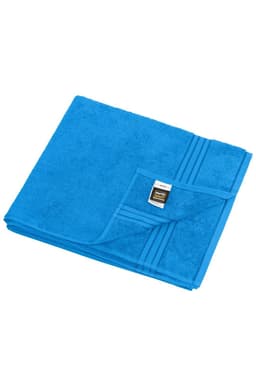 A blue sauna sheet folded neatly, featuring a textured surface and a small tag on the edge, with a logo.
