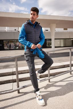 Fleece gloves in bright blue, displayed alongside a model wearing a blue and grey jacket, with casual pants and shoes.