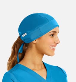 A unisex scrub cap in bright blue fabric, featuring a logo, designed for medical uniforms.