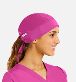 A unisex scrub cap in vibrant pink, featuring a tied back design and a small branding label.