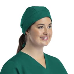 A green unisex scrub cap with buttons, worn by a smiling model in a scrub top.