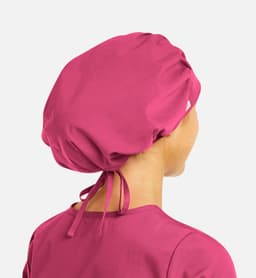 A unisex bouffant scrub cap in vibrant pink, featuring a gathered design and adjustable ties at the back.