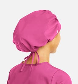 A unisex bouffant cap in vibrant pink, featuring a gathered design and adjustable ties at the back.