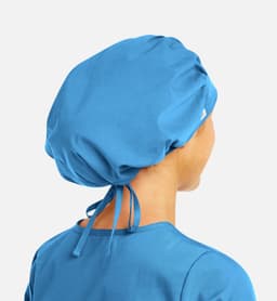 A unisex bouffant cap in blue, featuring a gathered design and adjustable ties at the back.