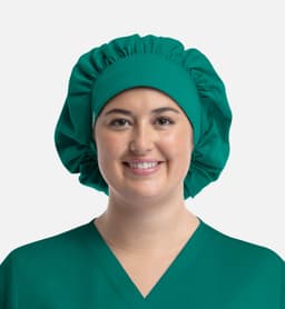 A unisex bouffant scrub cap in teal, designed for medical or uniform use, worn by a smiling individual.