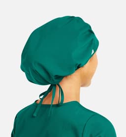 A unisex bouffant scrub cap in a vibrant teal colour, featuring a logo and adjustable ties at the back.