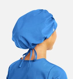 A unisex bouffant cap in bright blue with adjustable ties at the back, shown from the rear.