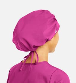 A unisex bouffant cap in a vibrant pink colour, featuring a drawstring tie at the back and a logo.