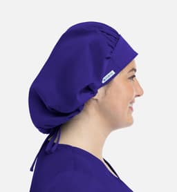 A unisex bouffant cap in purple, featuring a gathering at the back and a side logo.