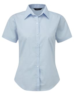 Light blue women's button-up blouse with short sleeves and a collared neckline, featuring a logo on the label.