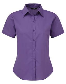 A purple short-sleeved button-up blouse with a collared neckline and a fitted silhouette. The shirt has a logo.